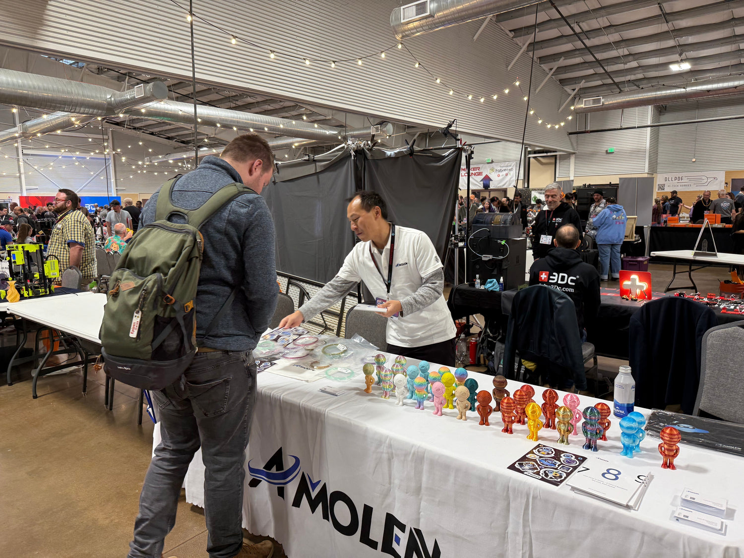 Amolen booth at RMRRF 2025, showcasing 3D - printed figures and engaging with attendees, as part of the brand’s community - building journey.